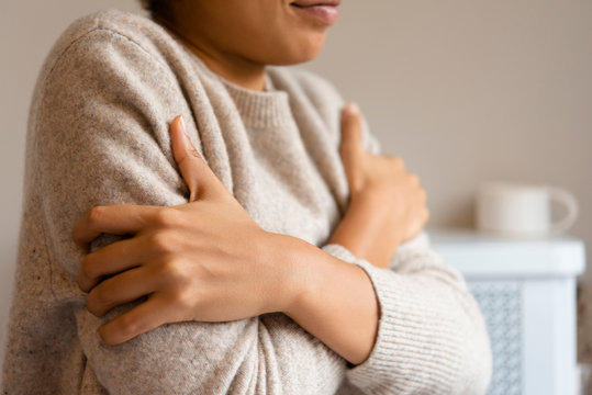 Crossed arms of woman in sweater