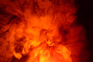 Fototapeta premium Imitation of bright flashes of orange-red flame. Background of abstract colored smoke.