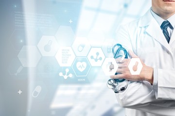 Obraz na płótnie Canvas Male doctor with stethoscope on blurred hospital background