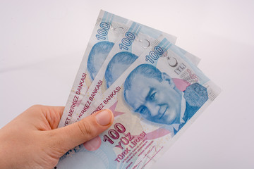 Hand holding 100 Turksh Lira banknotes  in hand