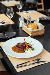 Wagyu Striploin with mashed truffle garlic confit, seasonal vegetables and red wine sauce.