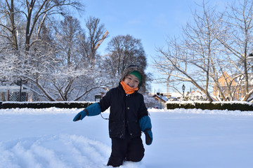 Kid playing in the snow winter time