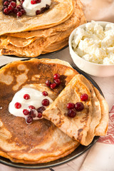 pancakes with sour cream and cranberries, pancakes with berries on a plate