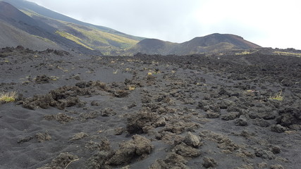 Mount Etna landscape with volcano craters and volcanological stone in Sicily, Italy