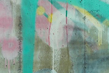 Colored abstract detail of a concrete wall with paint and stains.
