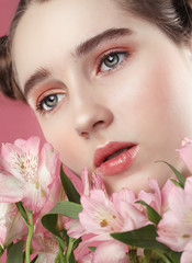 model with perfect make up and pink flowers