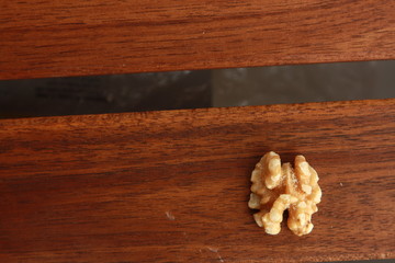 Peeled walnuts on wooden background