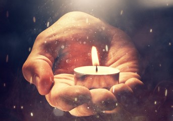 Burning candle in male hand,  religion concept