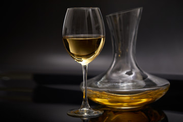 A glass full of wine and wine decanters