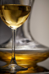 A glass full of wine and wine decanters