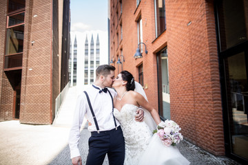 Bride and groom walking in the city, wedding day, marriage concept. Bride and groom in urban...