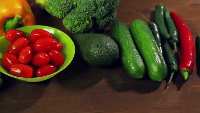 Fresh vegetables chili pepper, broccoli, avocado, zucchini on a wooden table. Close-up