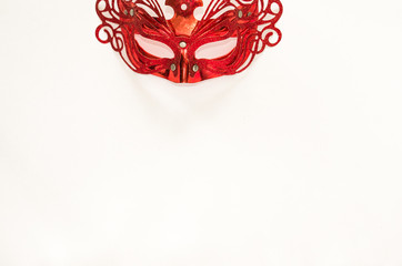 Red carnaval mask isolated on white table background. Flat lay style. Empty template