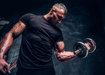 Muscular attractive bodybuilder lifting a barbell