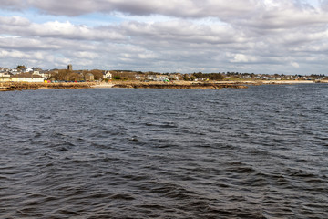 Beach with sand and buildings in Galway Bay
