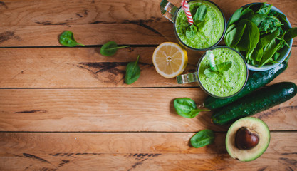 Close-up of green smoothie in a glass with fresh mint and ingredients, top view, copy space, text space