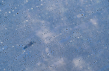 Background of the condensate drops on the film is polyethylene. Water drops texture