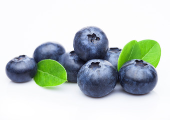 Fresh raw organic blueberries with leaf on white background. Macro close up