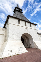 Fototapeta na wymiar White stone tower with wooden roof