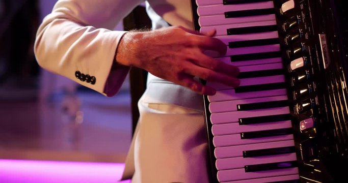 Musician playing accordion rehearsing music performance, 4K