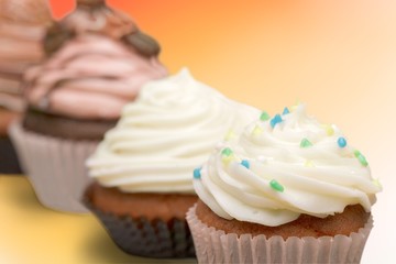Tasty Colorful cupcakes on background