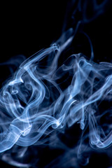 White and blue smoke isolated on a black background