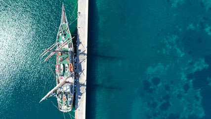 Aerial drone photo of vintage sail boat docked in mediterranean port
