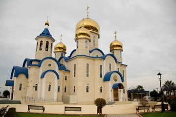 Fototapeta na wymiar Exterior architecture of Russian Orthodox church in Cyprus and cloudy sky 