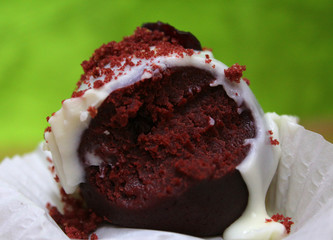 half-eaten cupcake on green background