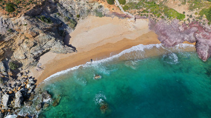 Aerial drone bird's eye view of famous emerald sea rocky beach of KAPE in area of Legrena, Sounio, Attica, Greece