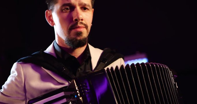 Not a ticketed event - Young male musician playing accordion rehearsing music performance, 4K