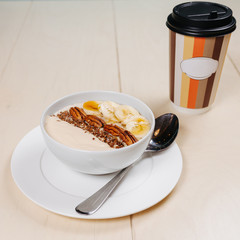 Breakfast, coffee, cereal, scrambled eggs, toast, bacon, nuts.