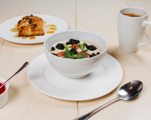 Breakfast, coffee, cereal, scrambled eggs, toast, bacon, nuts.