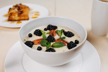 Breakfast, coffee, cereal, scrambled eggs, toast, bacon, nuts.