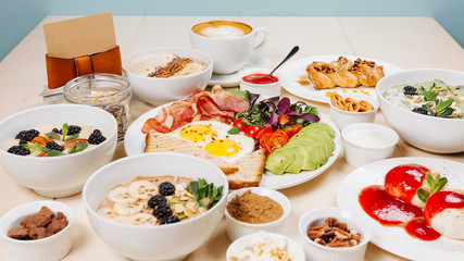 Breakfast, coffee, cereal, scrambled eggs, toast, bacon, nuts.