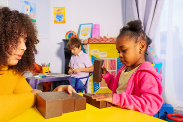 girl range and sort blocks by size in nursery