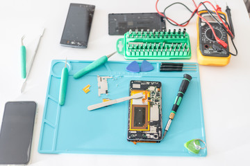 mobile phone parts and repairing tools, technician workspace.