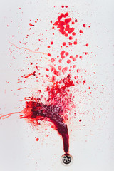 Blood draining from white bathroom basin. Bloody stains in the waterbasin hole. Sink run with blood...