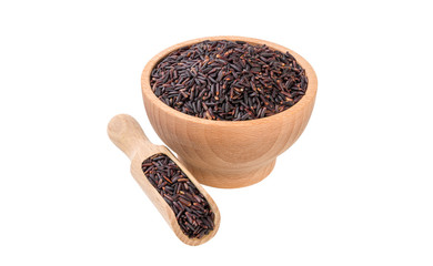 jasmine black rice in wooden bowl and scoop isolated on white background. nutrition. bio. natural food ingredient.