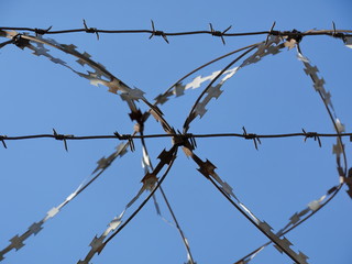 razor wire in the blue sky close to