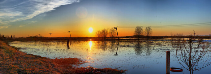 Panoramic views of the sunset over the fields from spring floods