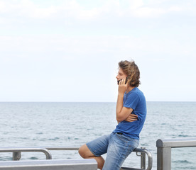 Teenage boy typing text message.Using smart phone.