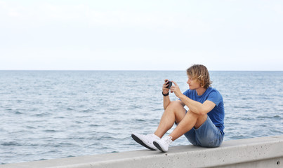 Fototapeta na wymiar Teenage boy typing text message.Using smart phone.