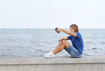 Fototapeta na wymiar Teenage boy typing text message.Using smart phone.