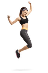 Fototapeta na wymiar Happy young female in sportswear jumping