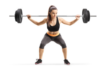 Fototapeta na wymiar Young female athlete lifting weigths