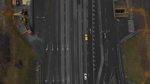 Top view of a major road in the city. Top view of the road junction. The camera is dropping over the road. Moscow, MKAD. Aerial view 4K