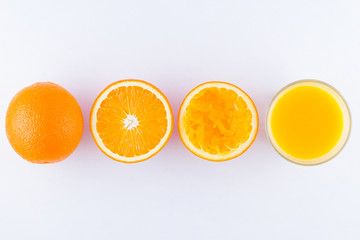 Orange fruits with juice, concept. Orange juice and halves of oranges on white background. Citrus for making juice. Whole and squeezed oranges and glass of juice