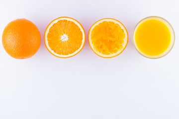 Orange fruits with juice, concept. Orange juice and halves of oranges on white background. Citrus for making juice. Whole and squeezed oranges and glass of juice