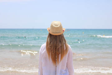 Fototapeta na wymiar Pretty blonde woman observing the beach